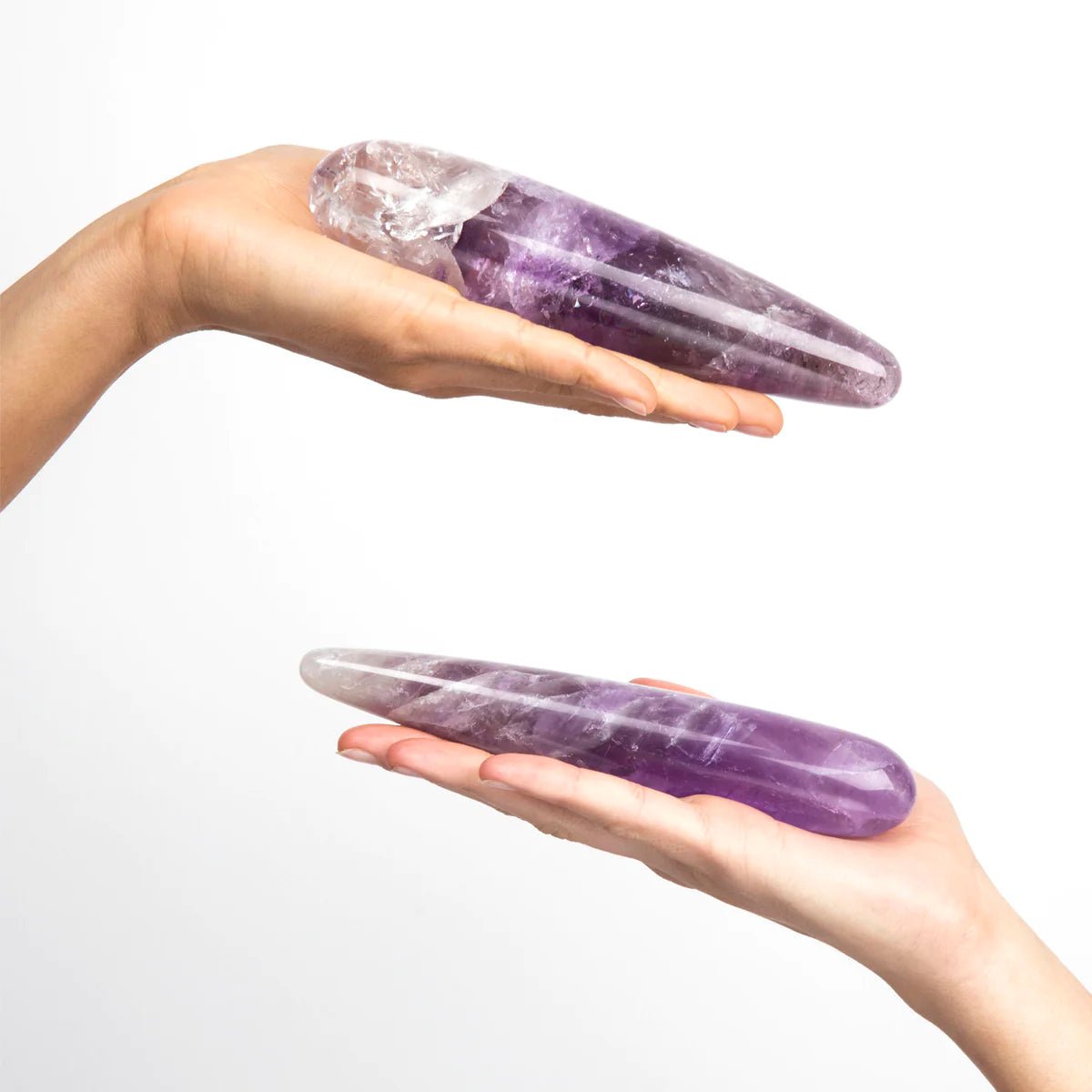 The Amethyst Original amethyst crystal dildo by Chakrubs held by hands at SugarX.