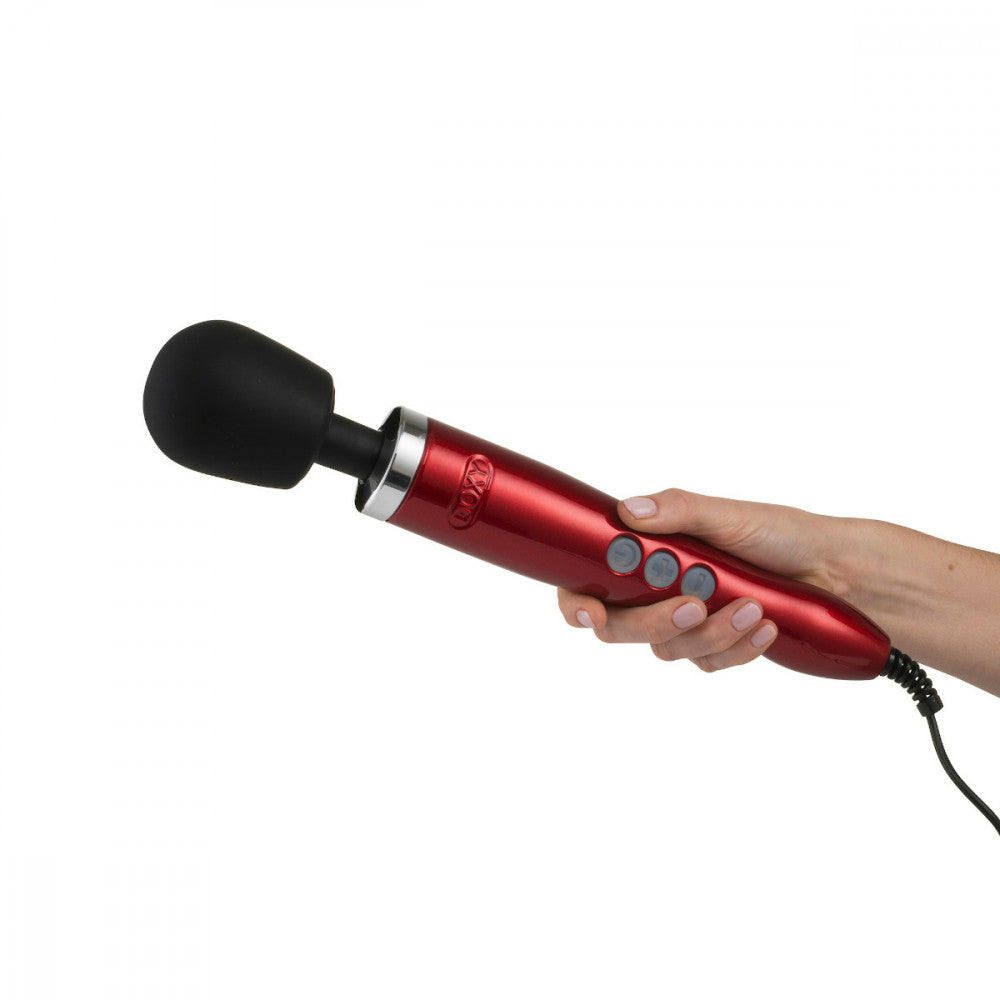 Hand holding the Doxy Die Cast Candy Red wand vibrator, showcasing ergonomic design and powerful vibration control. Buy this sex toy at SugarX in the Vibrators Collection.
