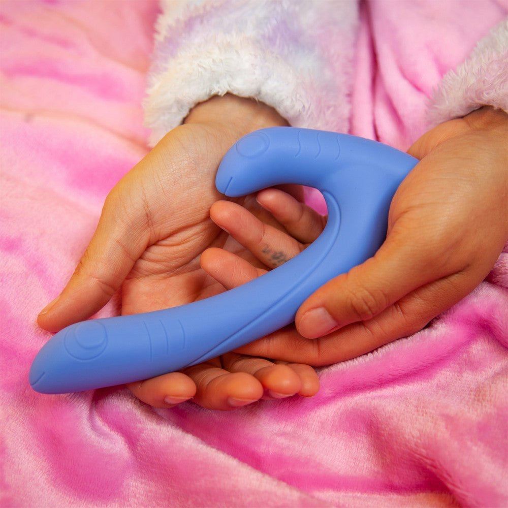 Hand holding the periwinkle Jix vibrator, showing its soft, flexible design ideal for all bodies.