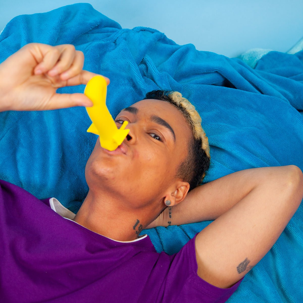 Shimmer vibrator in Sunshine color being kissed by a person. A joyful, inclusive pleasure toy designed for intimacy and comfort, available at SugarX
