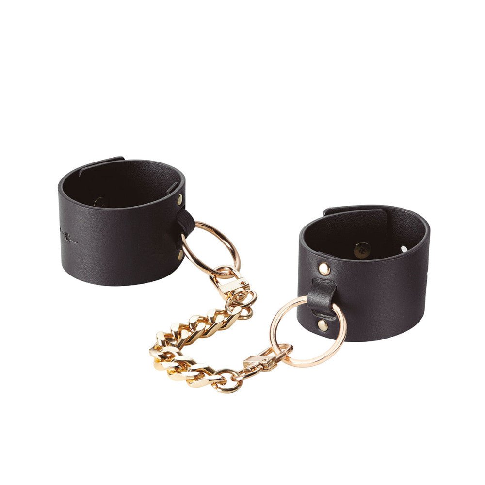 Bijoux Indiscrets Maze Wide Cuffs on a white background showcasing the vegan leather material and gold chain. Available at SugarX in the BDSM Fashion collection of the Sex-Positive accessories section.