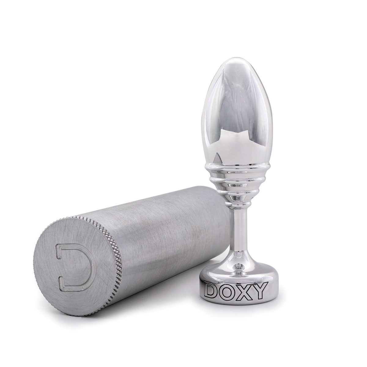 Doxy Ribbed Metal Butt Plug next to its brushed aluminum storage case which is lying on its side on a plain white background showcasing its tapered aluminum body and extra long stem. Available at SugarX in the Butt Plug section of the Sex Toys collection.