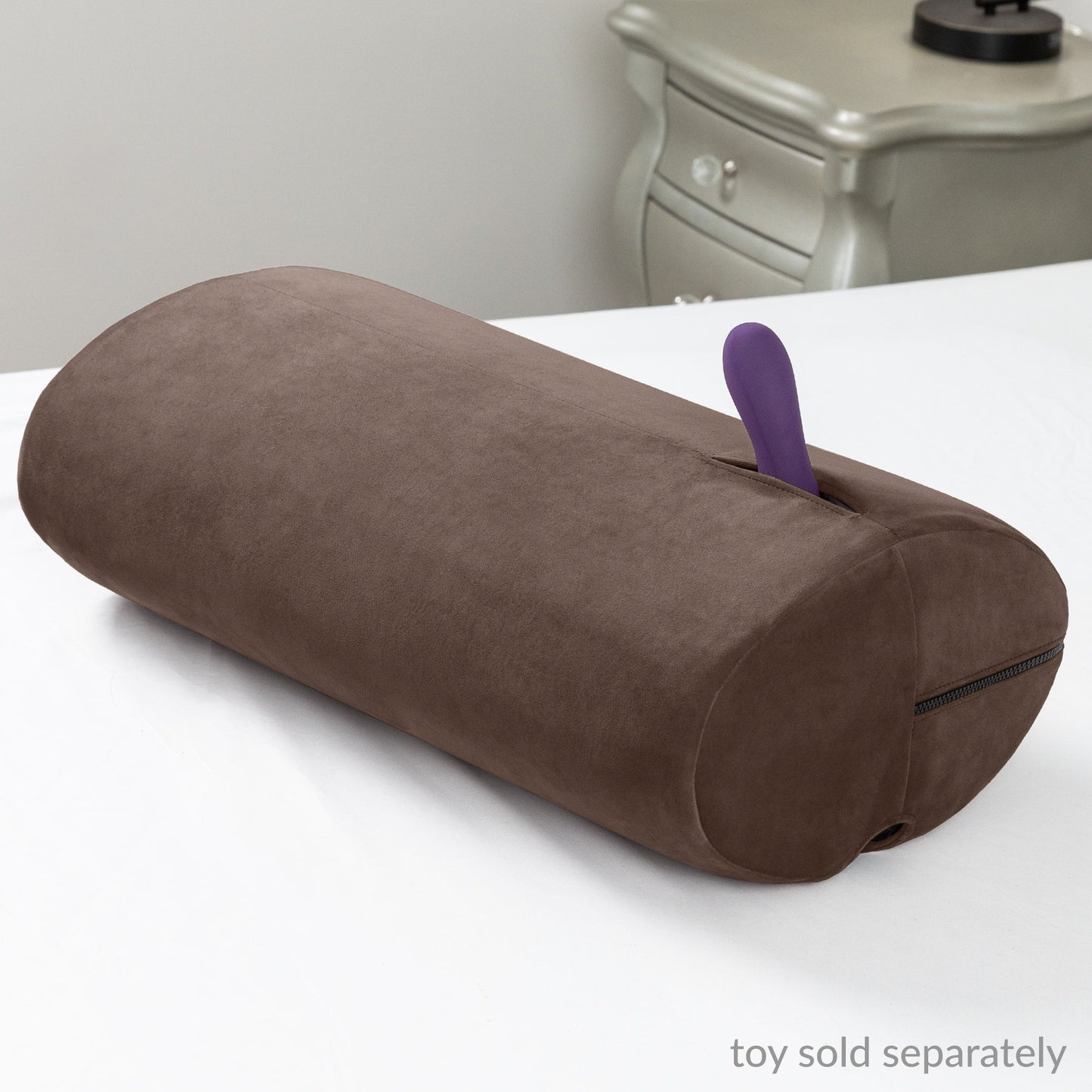 The stylish Espresso Liberator Wing sex toy mount, resting on a bed and ready for hands-free pleasure, available at SugarX.