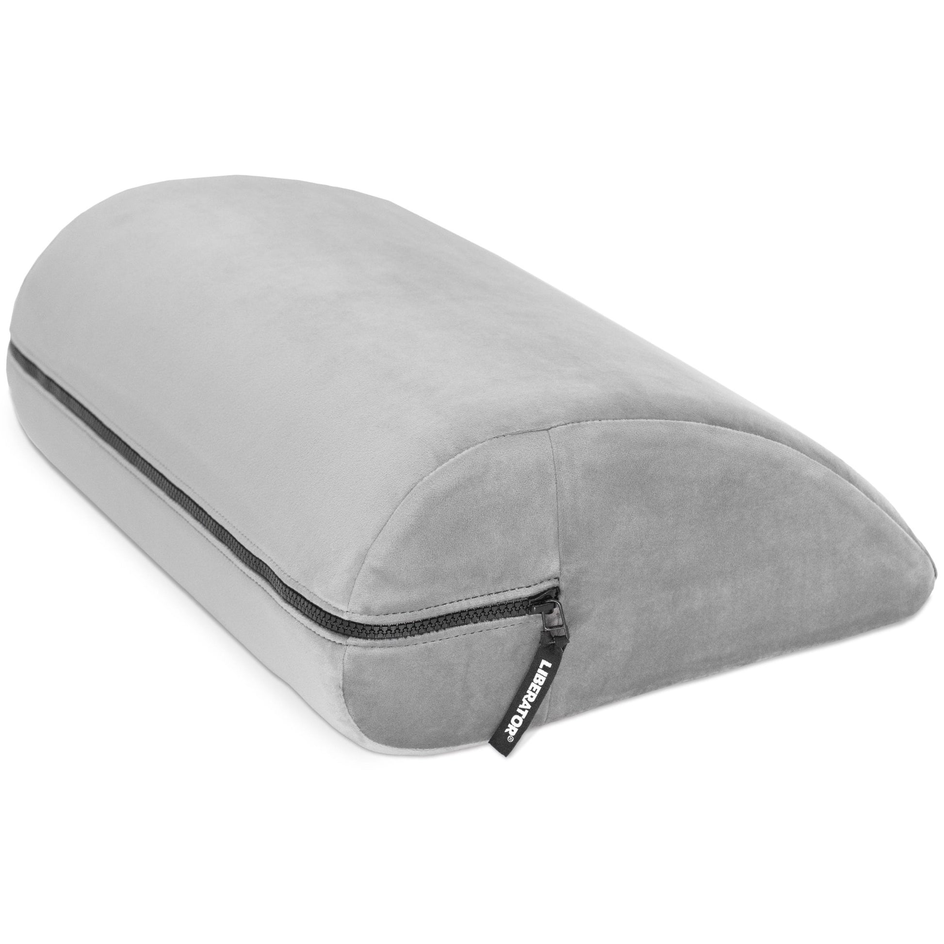 Close-up of the grey Liberator Jaz Motion pillow on a bed, showcasing the soft fabric and ergonomic design for enhanced pleasure at SugarX.