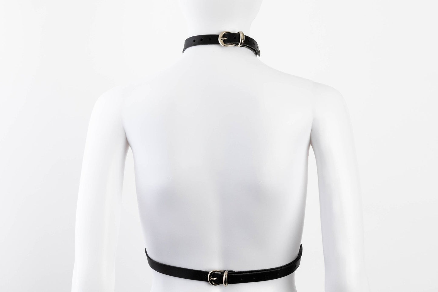 Liberator Lano Leather Chest Harness with adjustable straps, nickel-plated accents, and center O-ring for BDSM restraint and bondage play. Shop now at SugarX! Black harness.