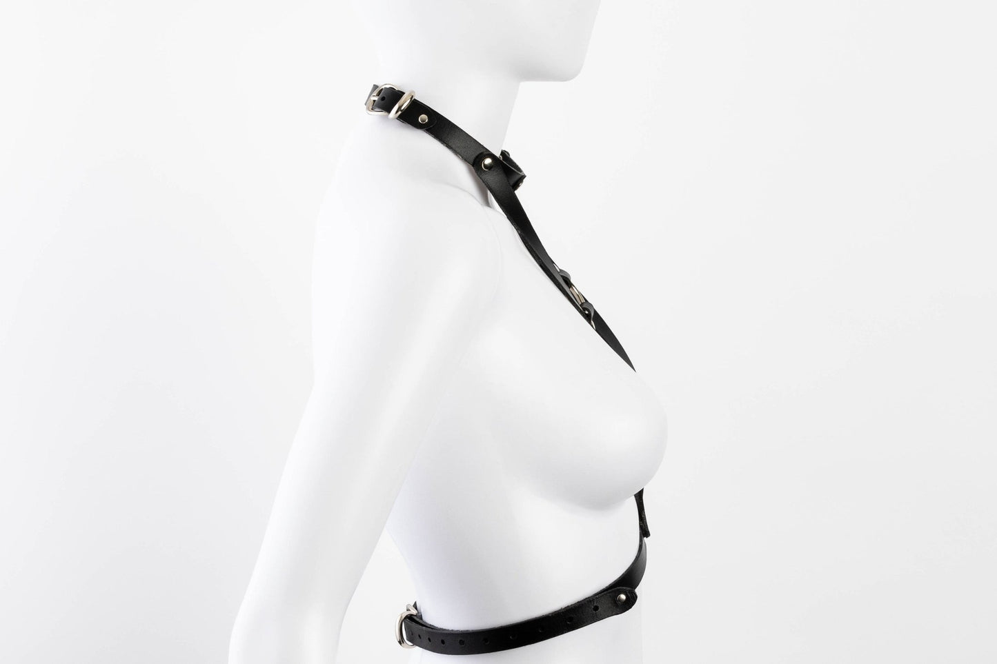 Liberator Lano Leather Chest Harness with adjustable straps, nickel-plated accents, and center O-ring for BDSM restraint and bondage play. Shop now at SugarX! Black harness.