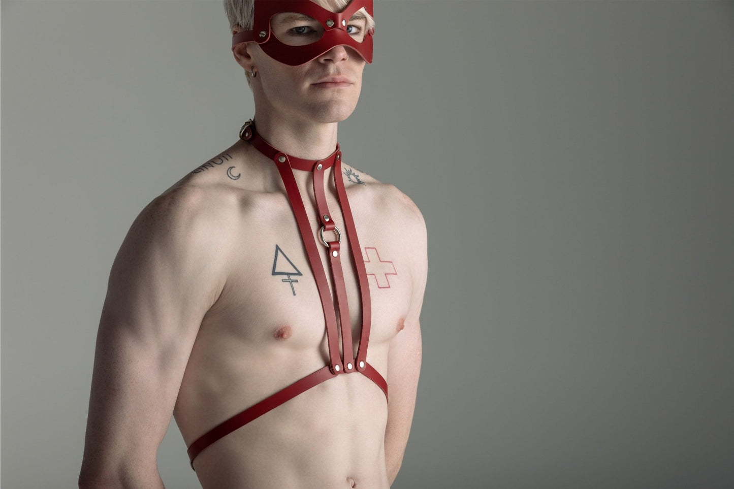 Liberator Lano Leather Chest Harness with adjustable straps, nickel-plated accents, and center O-ring for BDSM restraint and bondage play. Shop now at SugarX! Red harness, male harness, front view.
