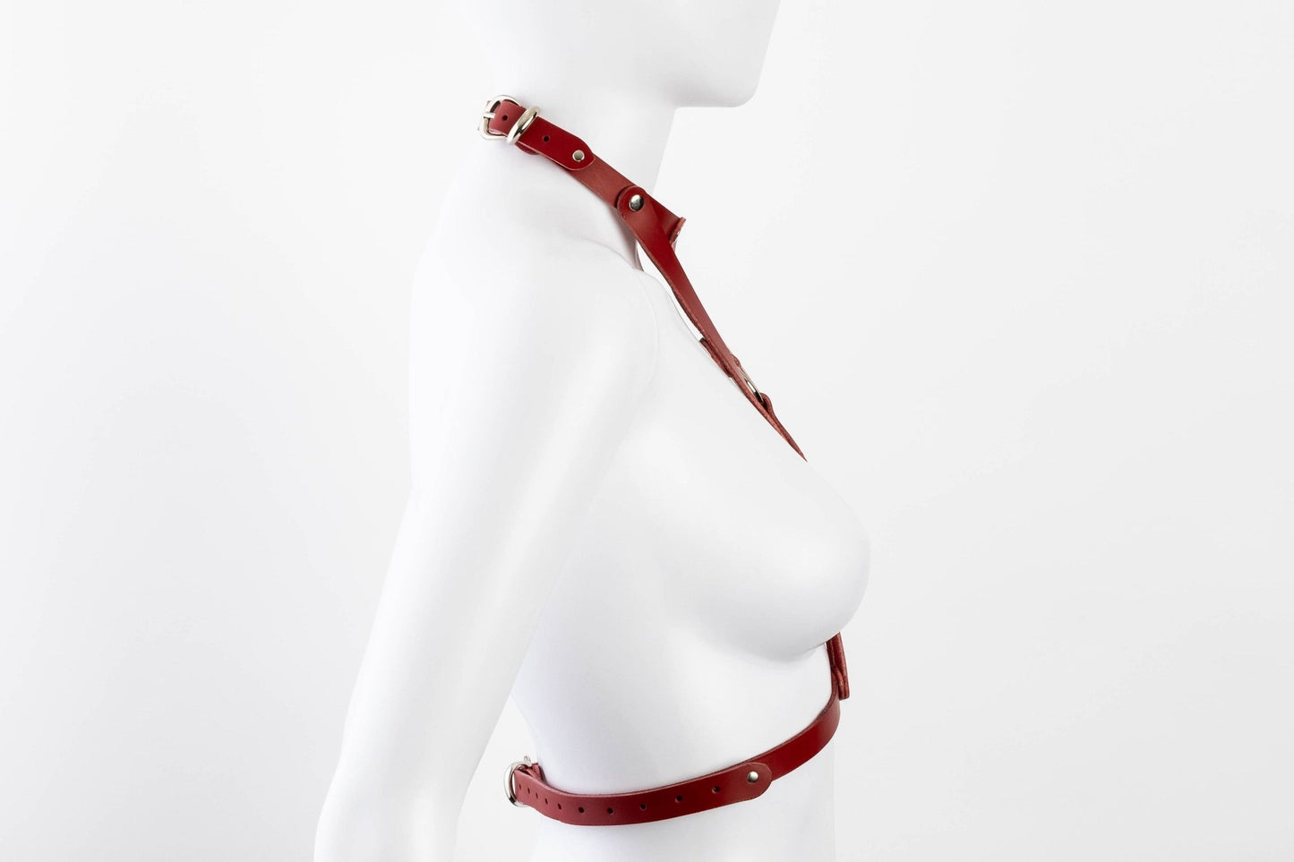 Liberator Lano Leather Chest Harness with adjustable straps, nickel-plated accents, and center O-ring for BDSM restraint and bondage play. Red, side view.