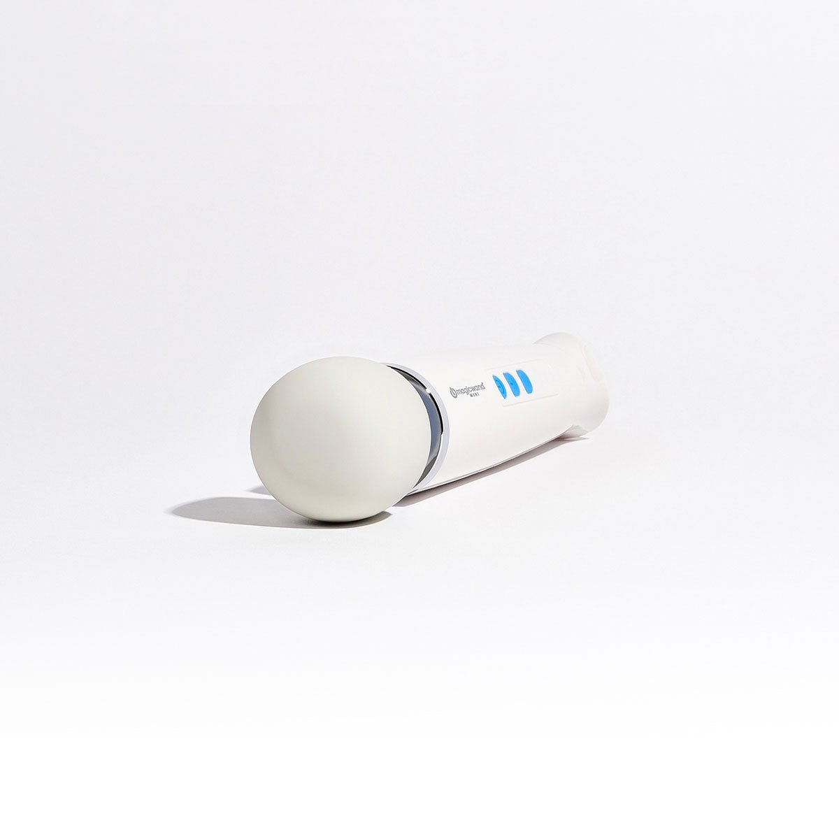 Magic Wand Mini Rechargeable vibrating wand sex toy lying down with its silicone head facing the camera on a plain white background. Available at SugarX in the Vibrating Wand section of the Sex Toy collection.