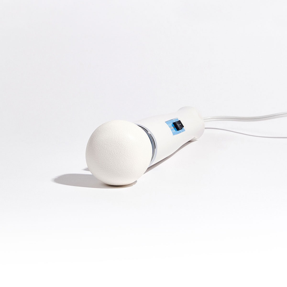 Magic Wand Original Vibrating Wand lying with its silicone head facing the camera on a plain white background. Available at SugarX in the Vibrating Wand section of the Sex Toy collection.