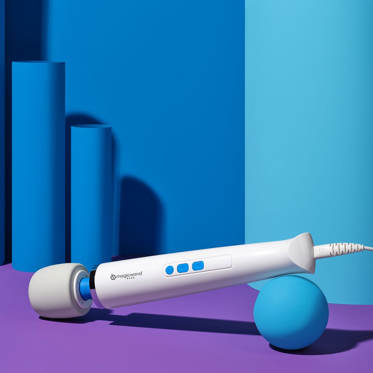 Magic Wand Plus vibrating wand sex toy lying facing downwards on a blue background. Available at SugarX in the Vibrating Wand section of the Sex Toy collection.