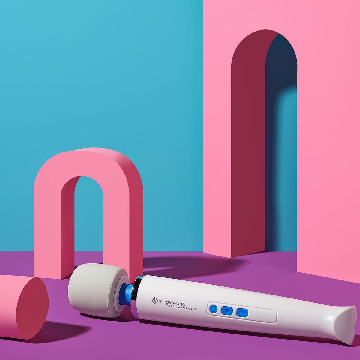 Magic Wand Rechargeable vibrating wand sex toy lying inclined on a colorful background. Available at SugarX in the Vibrating Wand section of the Sex Toy collection.