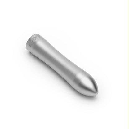 Doxy Bullet vibrator in silver lying horizontally on a plain white background, highlighting its sleek shape and ergonomic curves for ultimate comfort. Available at SugarX in the Vibrators Collection.