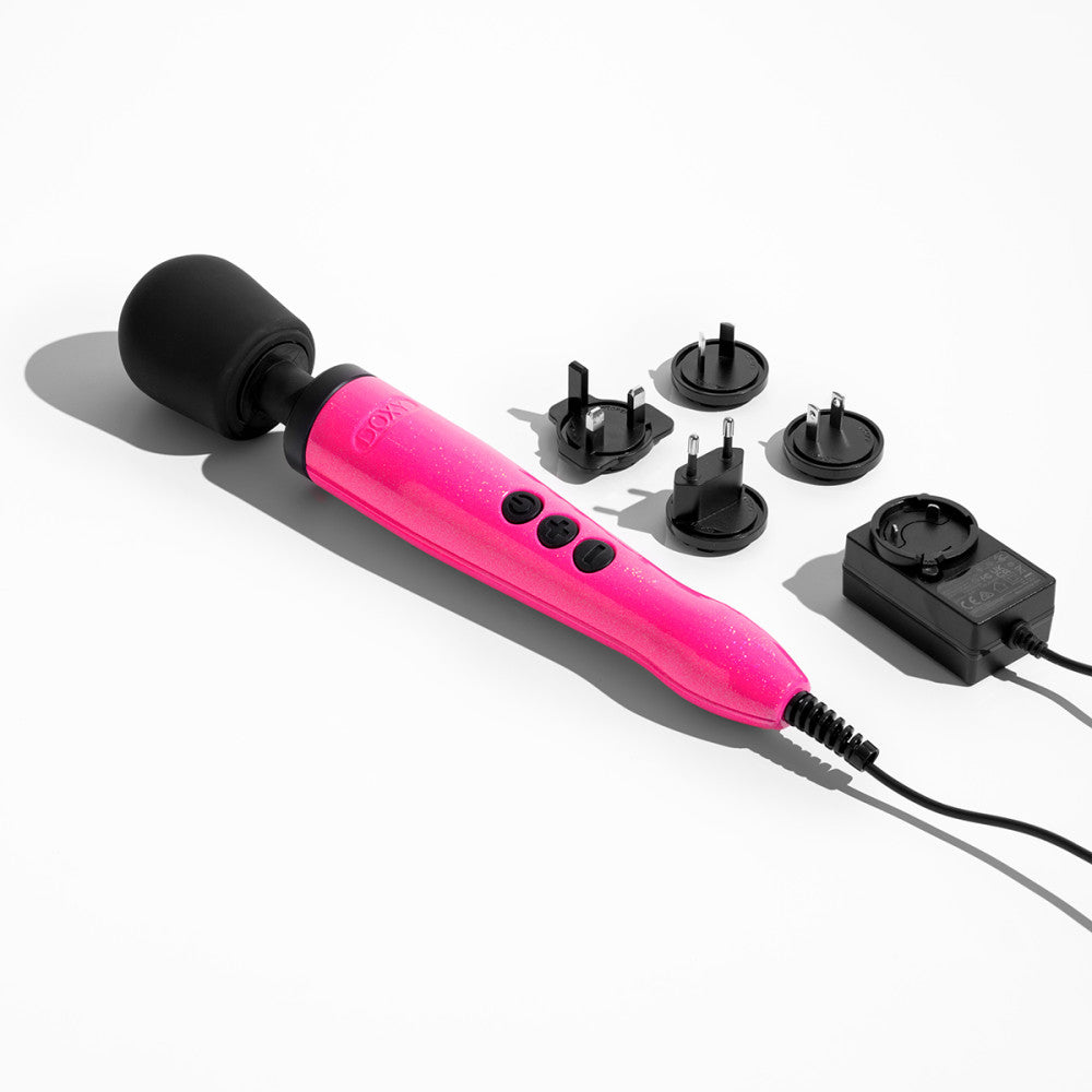 Doxy Die Cast Hot Pink wand vibrator displayed alongside four plug adapters on a white background. Versatile sex toy with international compatibility, available at SugarX in the Vibrators Collection.