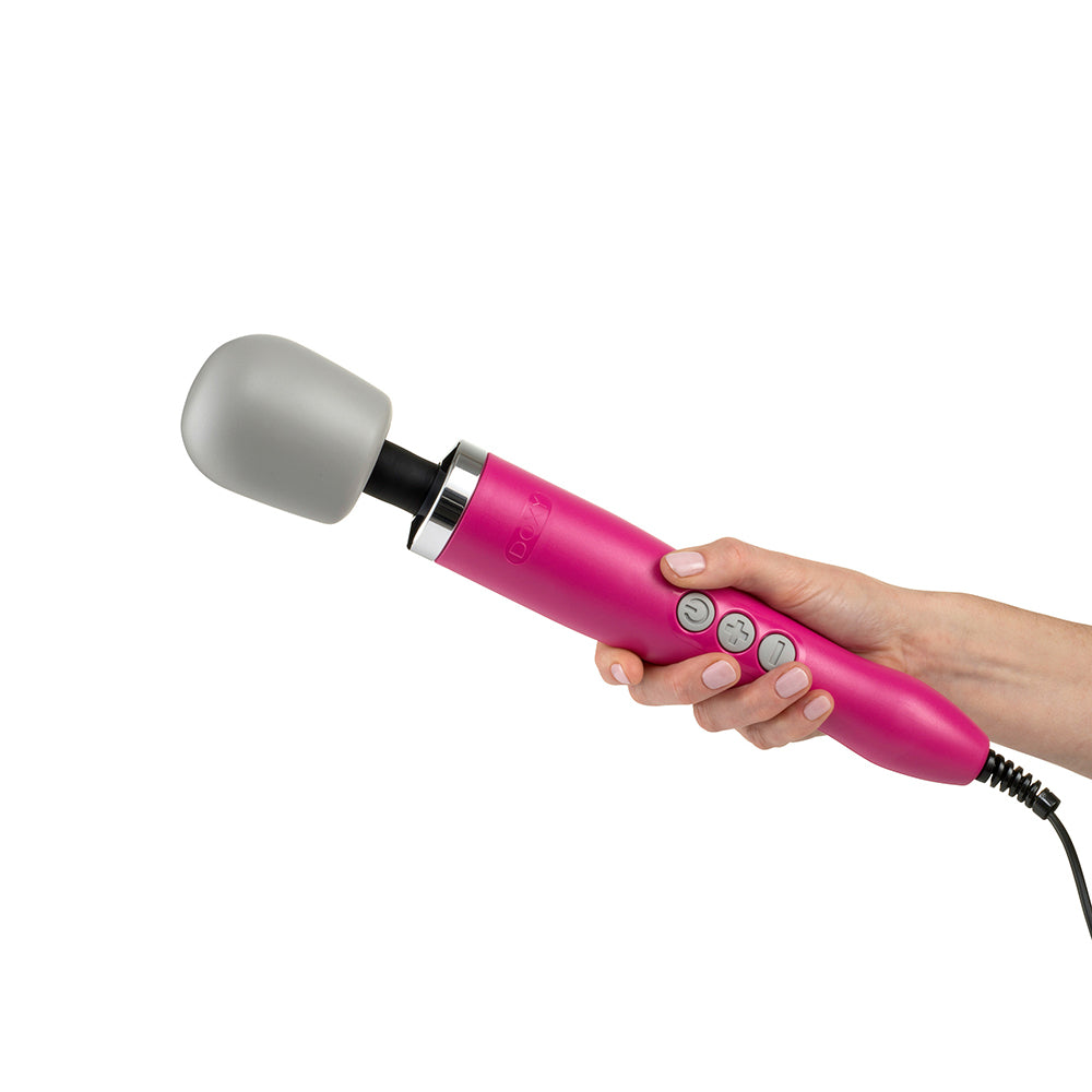 Hand holding the Doxy Original Massager wand vibrator in pink on a plain white background. Available at SugarX in the Vibrators Collection.