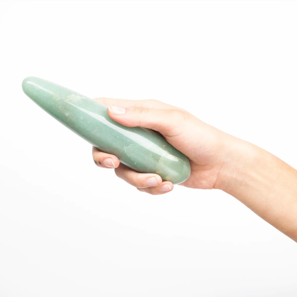 The Indian Jade Original by Chakrubs, a non-phallic green aventurine crystal dildo being held by a hand on a white background. Available at SugarX in Sex Toys in the Dildo collection. 