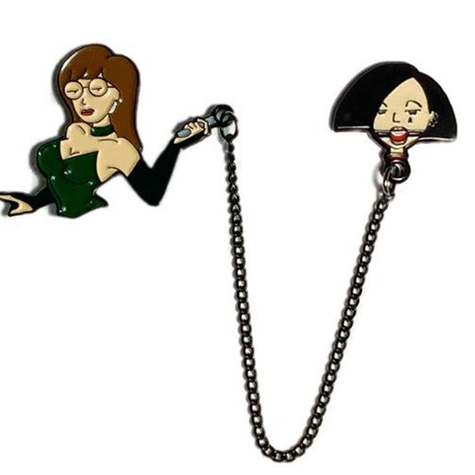 Geeky & Kinky Mistress D & Sub J Duo Pin displayed showcasing its design. Available at SugarX in Jewelry in the Pins collection.