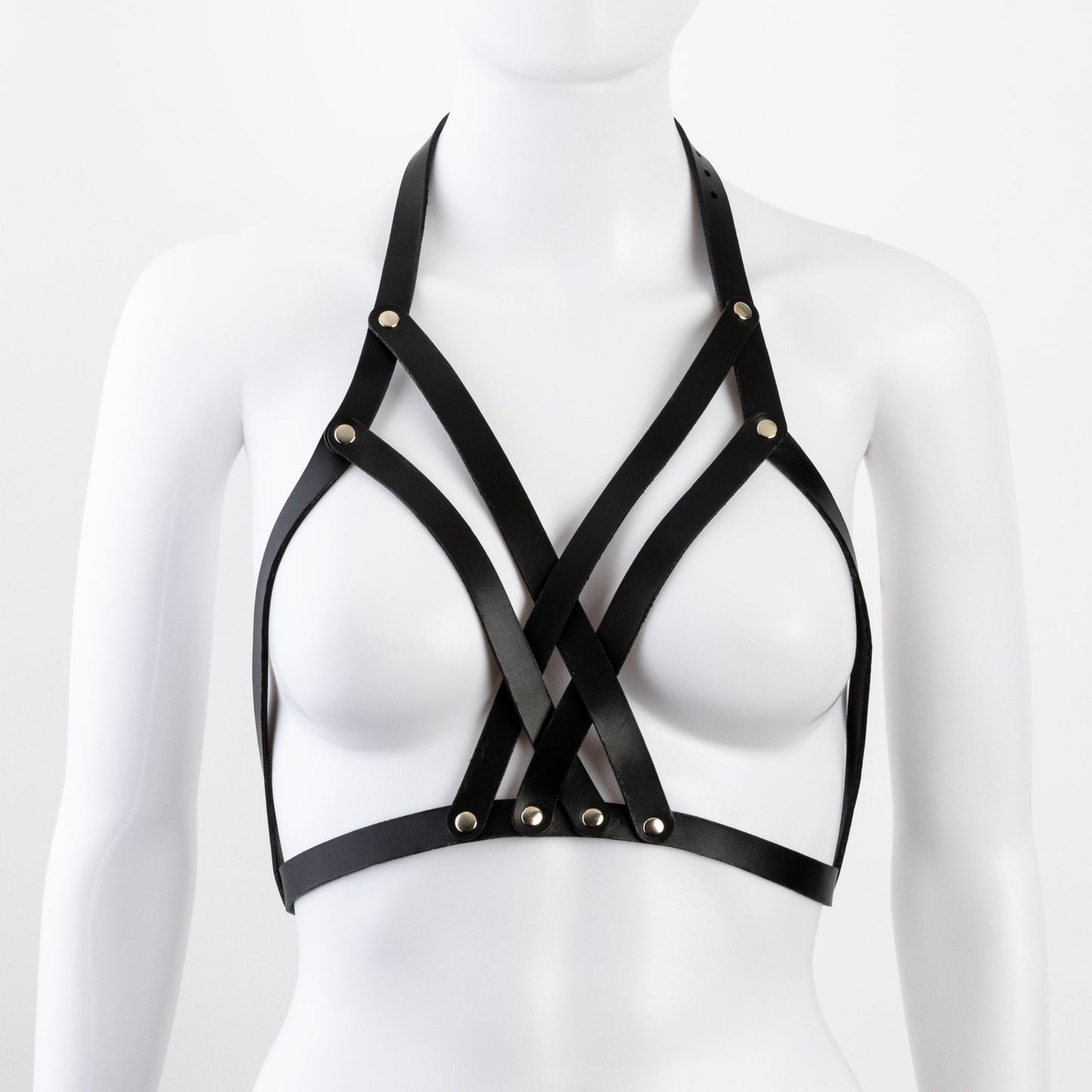 Front view of black leather Liberator Galway Harness on mannequin bust, featuring a central chest strap matrix with nickel-plated rivets at SugarX