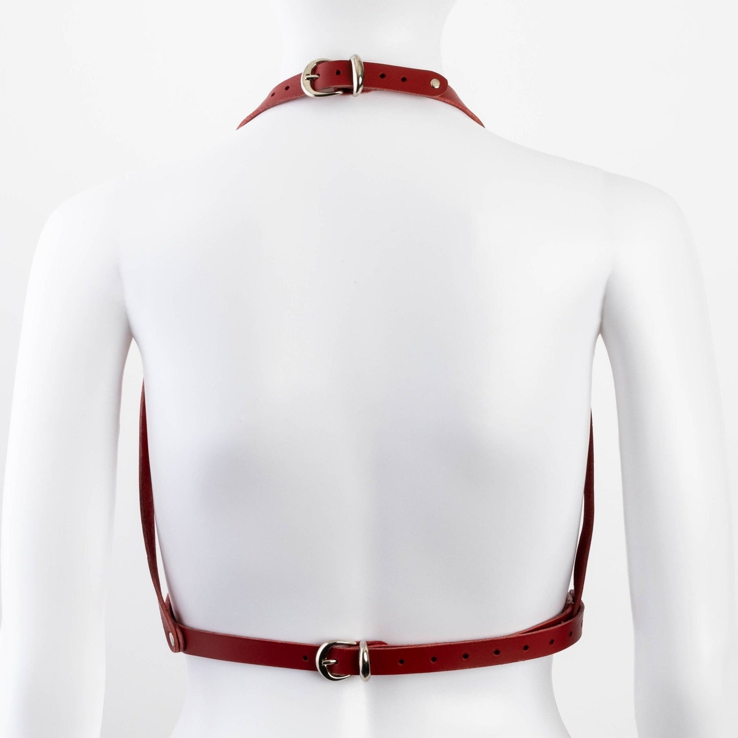 Back view of red Liberator Galway Harness on mannequin, displaying the open-back design and durable rivets for a BDSM look at SugarX.