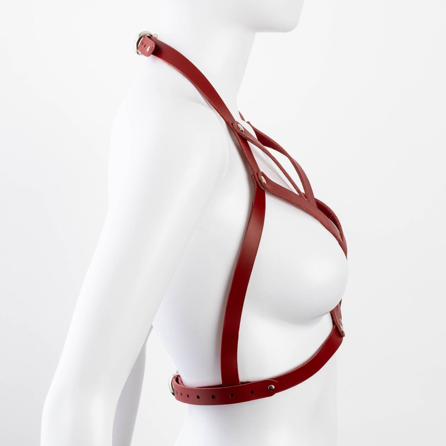 Side view of red Liberator Galway Harness on mannequin, highlighting the sleek leather construction and adjustable buckle for a custom fit at SugarX.