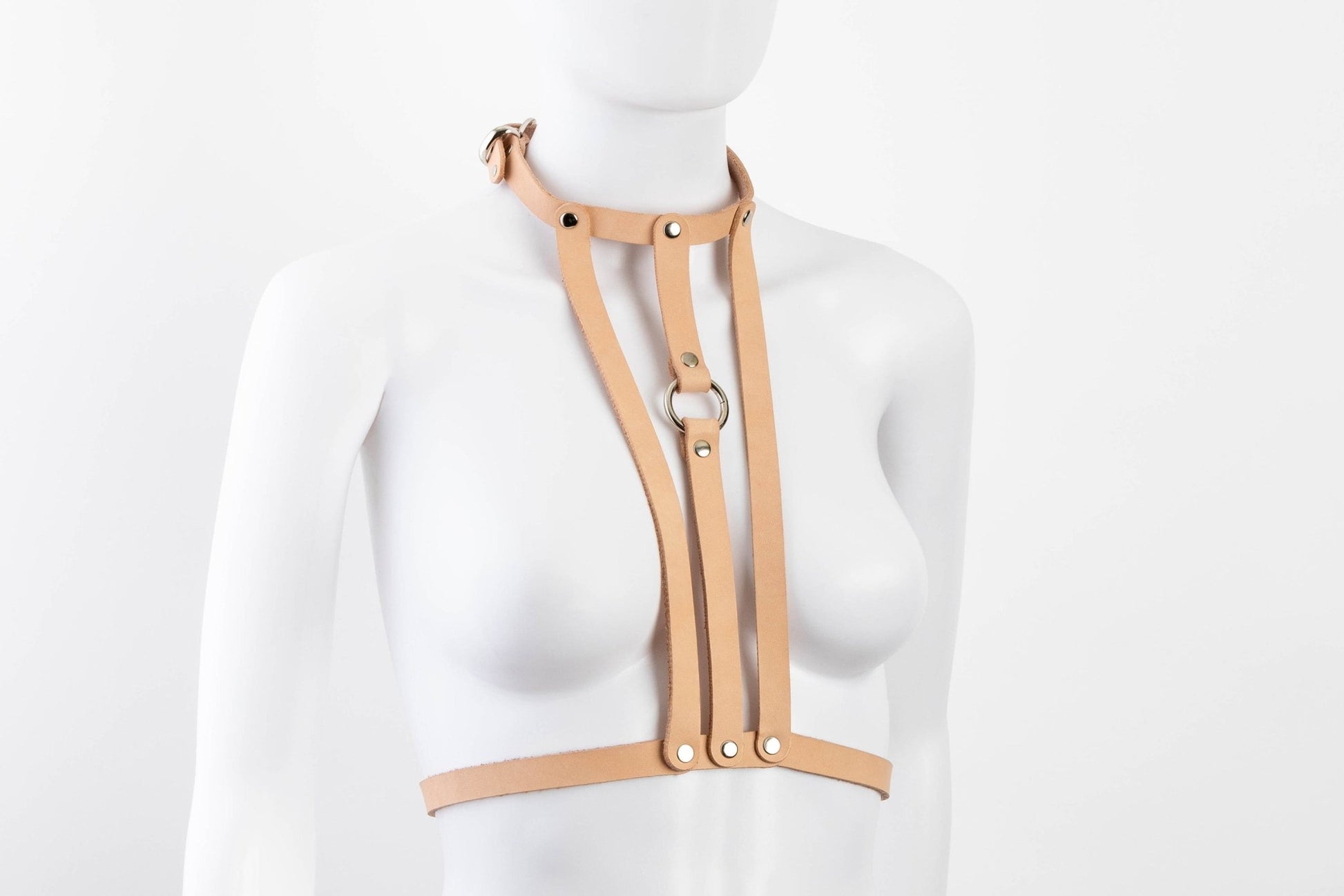 Liberator Lano Leather Chest Harness with adjustable straps, nickel-plated accents, and center O-ring for BDSM restraint and bondage play.  Shop now at SugarX! Tan harness, angle view.