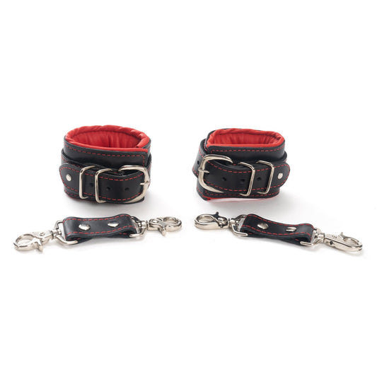 Black and Red Mercer Padded Leather Wrist Cuffs laid out, emphasizing both style and secure restraint for bondage enthusiasts at SugarX.